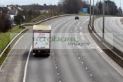 tesco-supermarket-distribution-truck-on-almost-empty-m2-motorway-during-coronavirus-lockdown-in-Newtownabbey-Northern-Ireland-UK