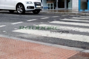 car-waiting-at-textured-pedestrian-crossing-pavement-in-the-wet-in-the-uk