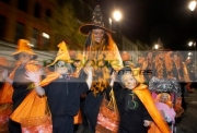 schoolchildren-teachers-dressed-as-orange-pumpkins-parade-down-shipquay-street-Halloween-Derry-Ireland