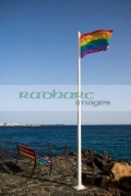 lgbtq-rainbow-flag-bench-on-the-seafront-playa-blanca-indicating-gay-lesbian-bi-trans-friendly-resort-location-Lanzarote-canary-islands-spain