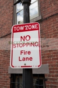 sign-for-tow-zone-no-stopping-fire-lane-in-historic-downtown-Boston-USA