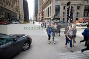 car-waiting-to-turn-right-as-pedestrians-cross-crosswalk-on-michigan-avenue-chicago-illinois-united-states-america